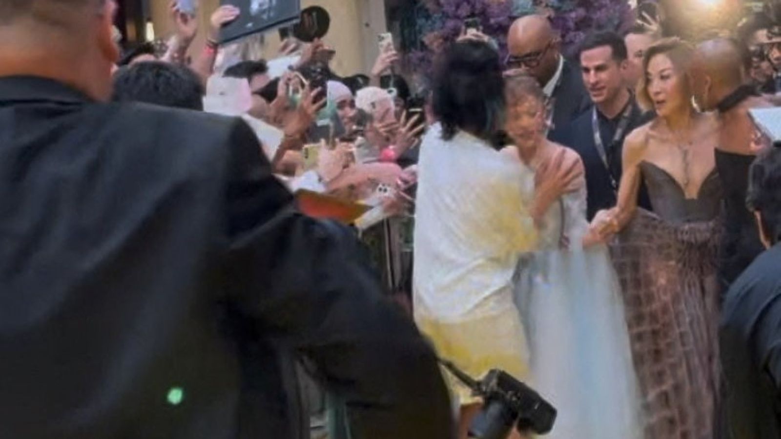 ariana-grande-rushed-by-red-carpet-intruder-at-film-premiere